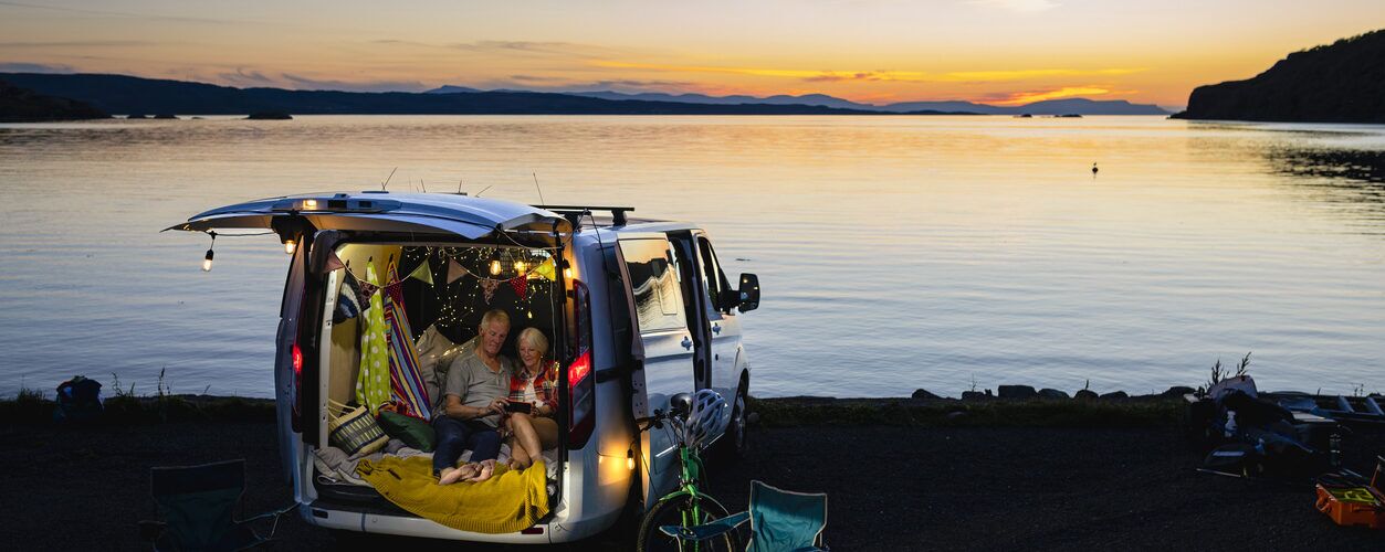 here is an image of a campervan lit up in the evening showing how a leisure battery is needed for campervan electrics
